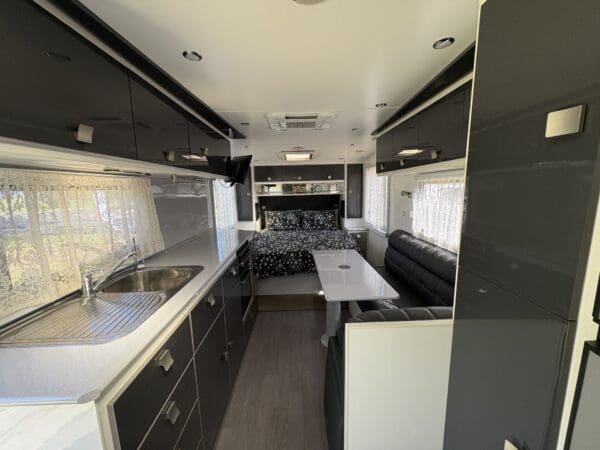  'L' SHAPE LOUNGE WITH FOOTRESTS - CONVERTS TO AN EXTRA BED